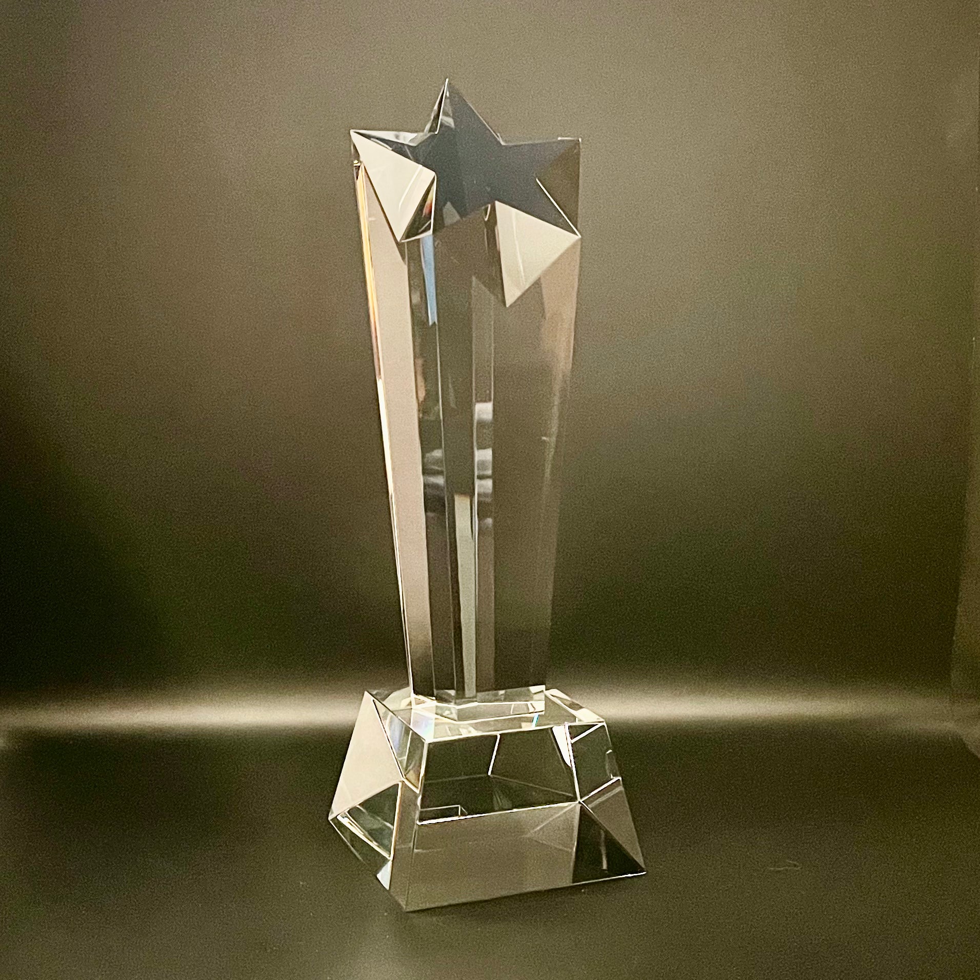 Crystal star-shaped trophy on a dark background