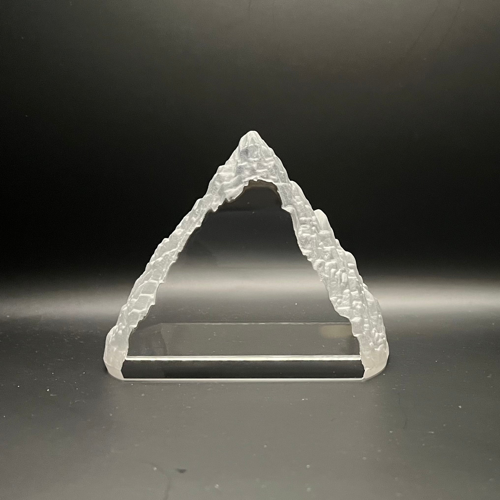 Triangular crystal mountain object on a black background