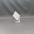 A clear crystal or glass geometric crystal tower with a diamond-shaped top and a square base.