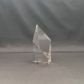 A clear acrylic or glass geometric trophy award stand with a faceted crystal-like design.