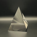 Clear pyramid-shaped object on a dark background