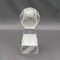 A clear crystal baseball trophy on a base 