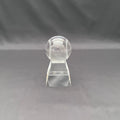 A clear crystal baseball trophy on a matching clear acrylic stand, photographed against a dark gray fabric backdrop.