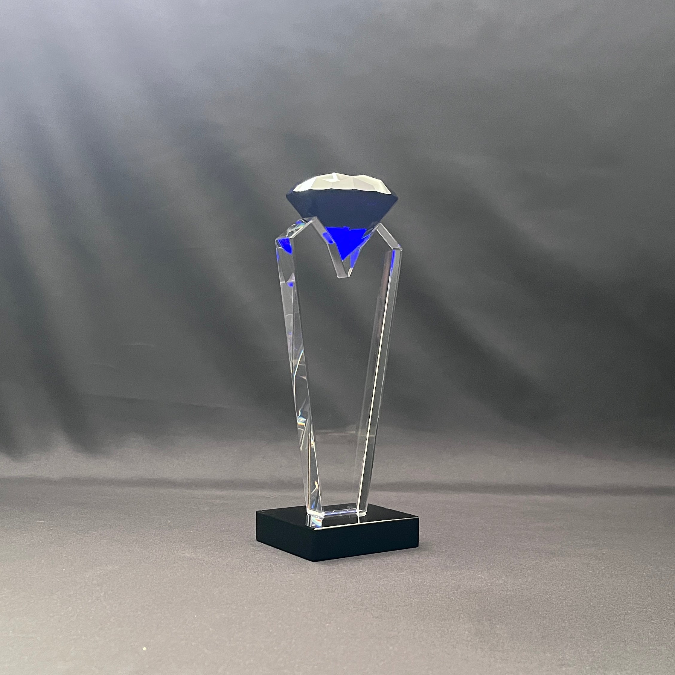 Blue crystal diamond on top of clear crystal base 
