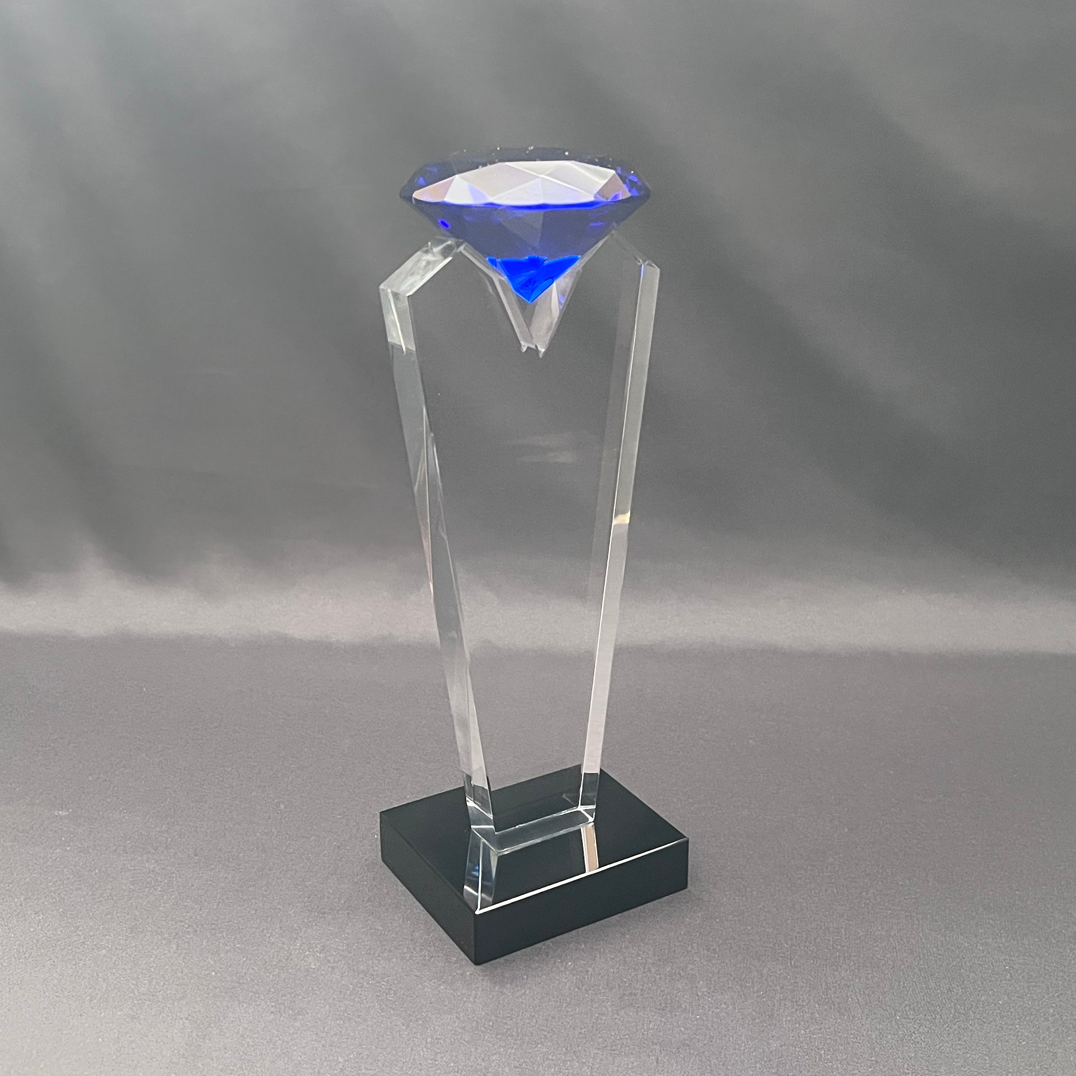 Side view of blue diamond on clear and black base 
