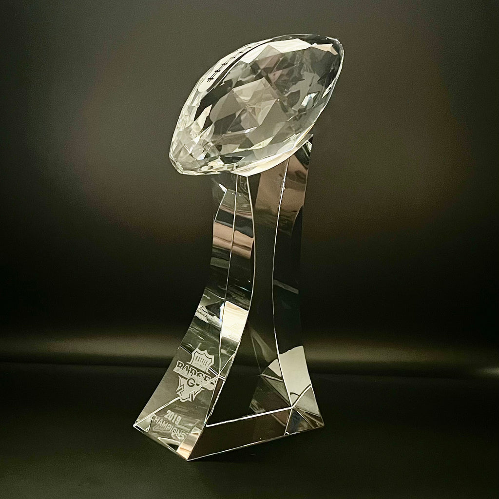 Crystal football trophy on a dark background