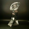 Crystal football trophy on a dark background