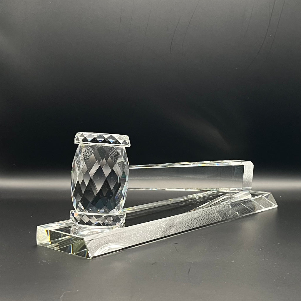 Crystal gavel on base with a dark background