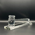 Crystal gavel on base with a dark background