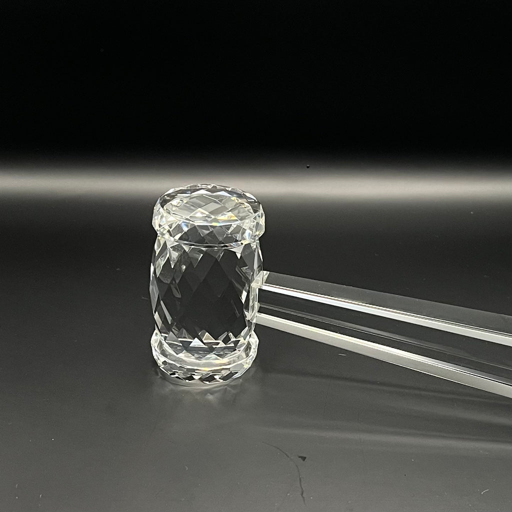 Clear crystal mace on a black background