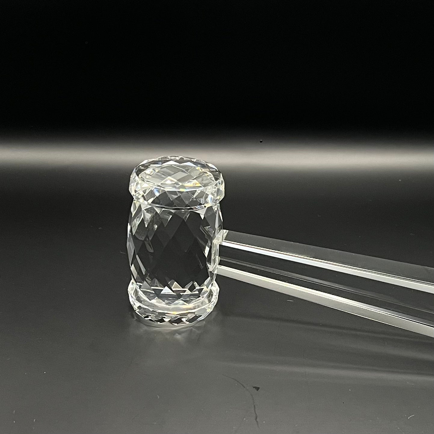 Clear crystal mace on a black background