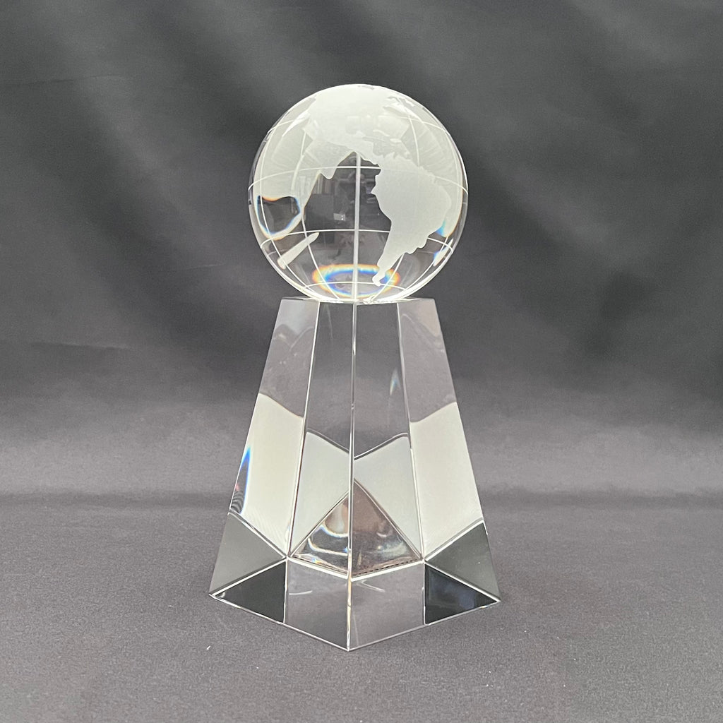 A clear  crystal or glass crystal award trophy featuring an etched globe on a crystal base 