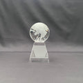 A clear glass world globe trophy on a geometric stand 