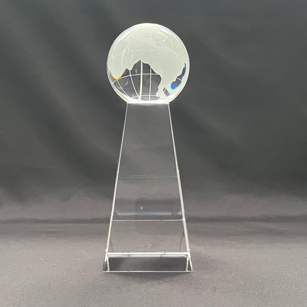 A clear crystal globe trophy on a matching pedestal 