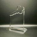 Clear crystal key-shaped award on a dark background