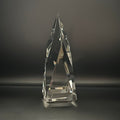 Clear crystal pyramid-shaped trophy on a dark background