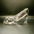 Clear crystal high-heeled shoe on a dark background