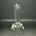 Clear crystal trophy with star design on a dark gray background
