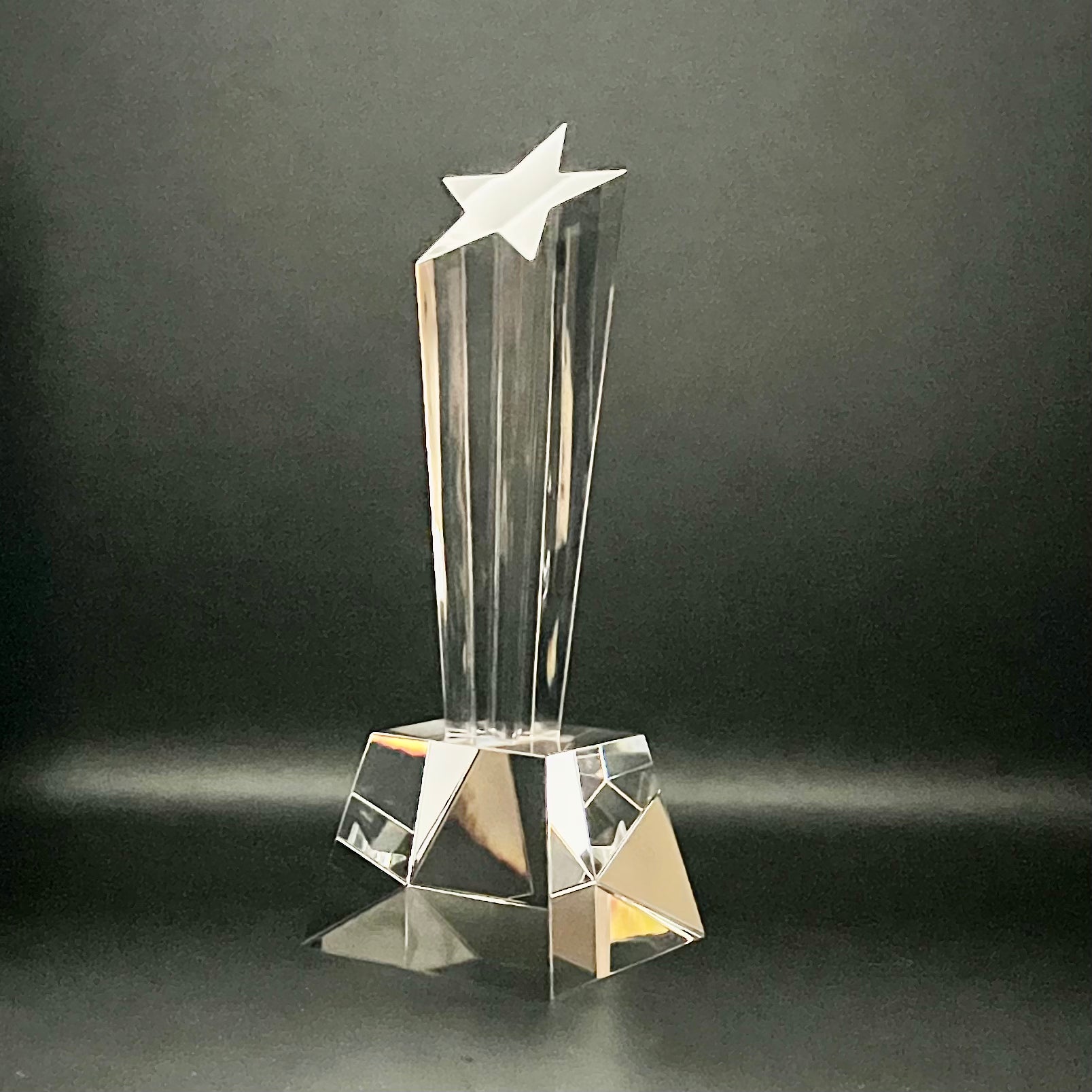 Clear crystal trophy with star on a dark background