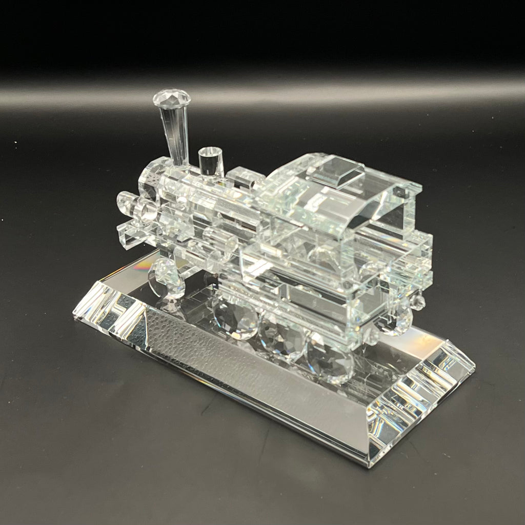 Clear crystal model of a train on a black background