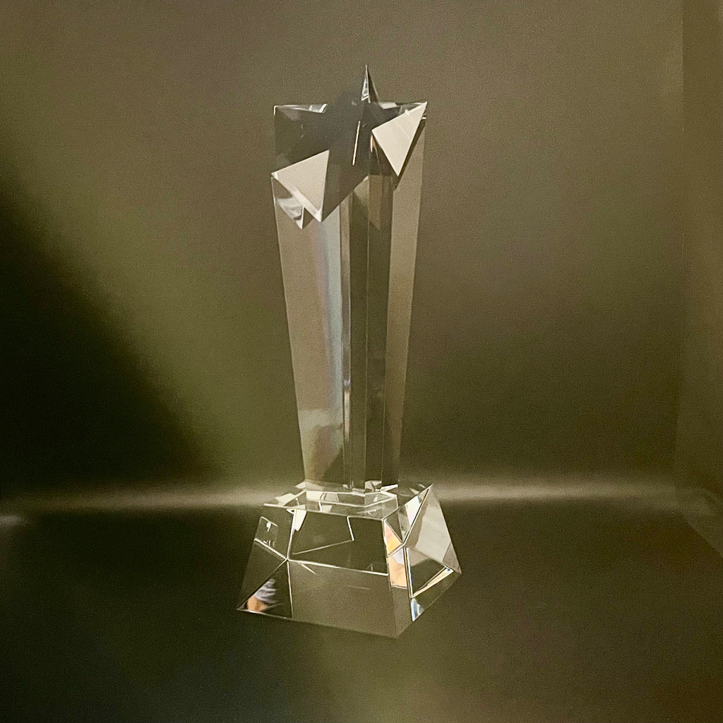 Crystal award with star design on a dark background