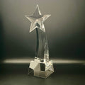 Clear crystal star-shaped trophy on a dark background