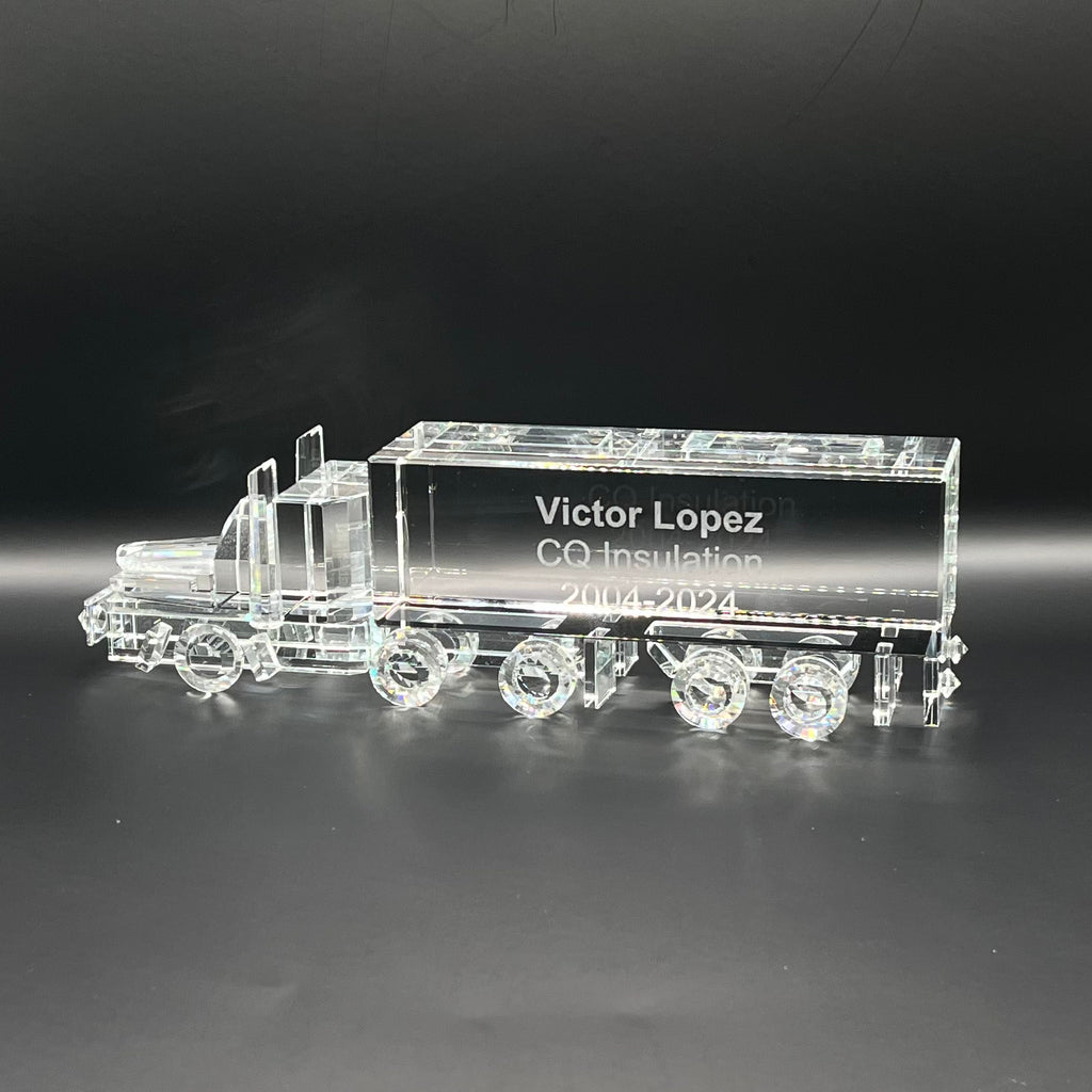 Crystal truck model with engraved text on a dark background