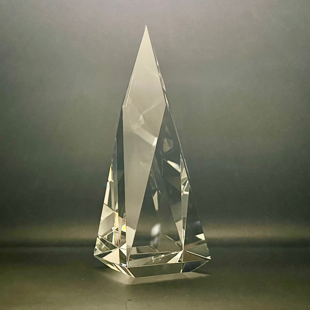 Clear crystal pyramid on a dark background