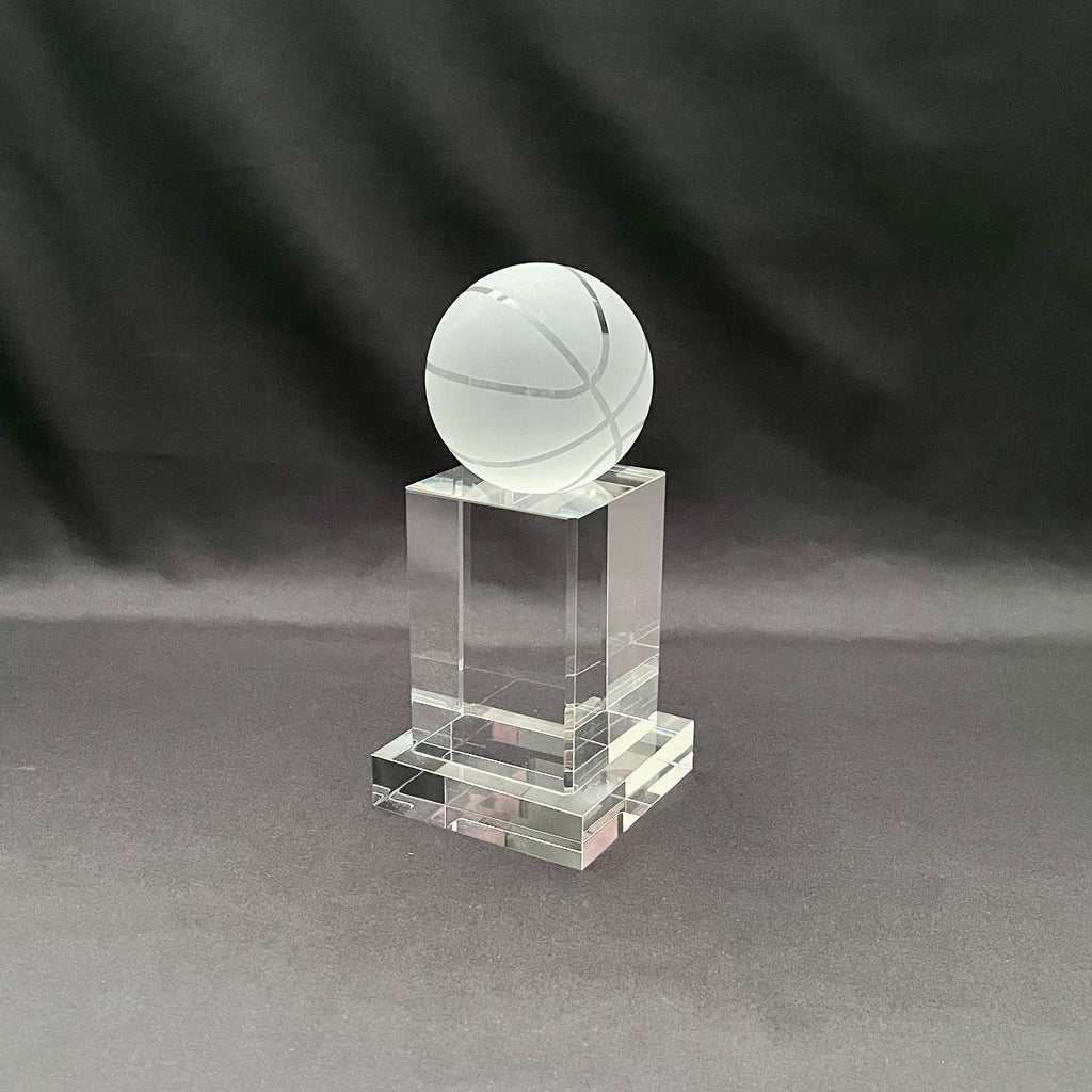 A clear acrylic trophy stand featuring a frosted white basketball ornament